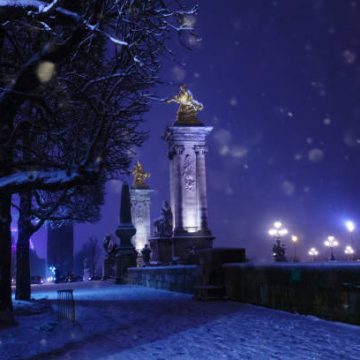 Bridge Pont Alexandre III columns during night under snow winter, Paris, France